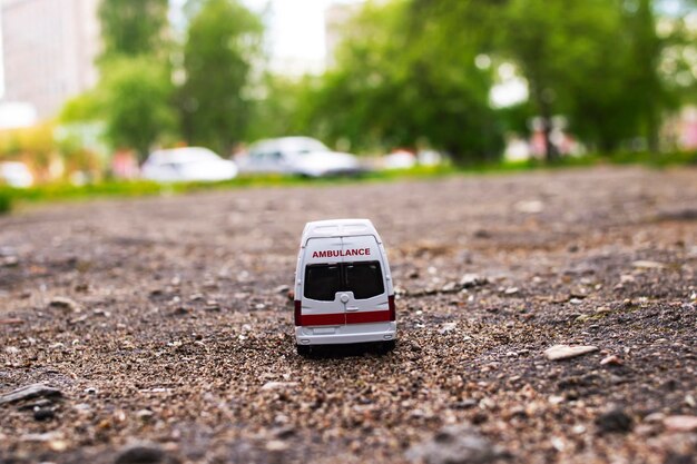 Ambulance car on the asphalt among the trees