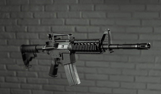 The American army rifle M4A1 against a brick wall