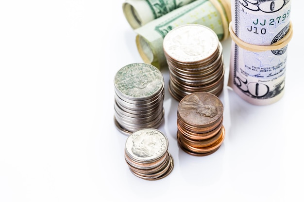 American bills and coins on a white backgreound.