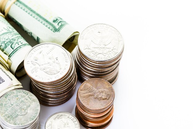 American bills and coins on a white backgreound.