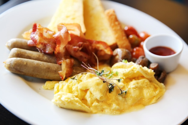 American Breakfast with bacon , scrambled egg on wood background