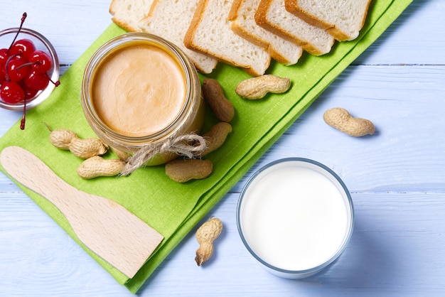 American breakfast with glass of milk and peanut butter and bread.