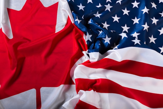 American and Canadian flags together