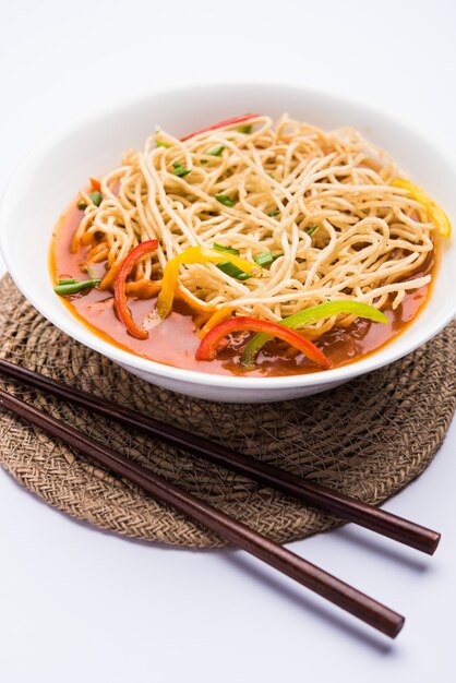 American chop suey or chopsuey is a popular indochinese food. served in a bowl with chop sticks. selective focus