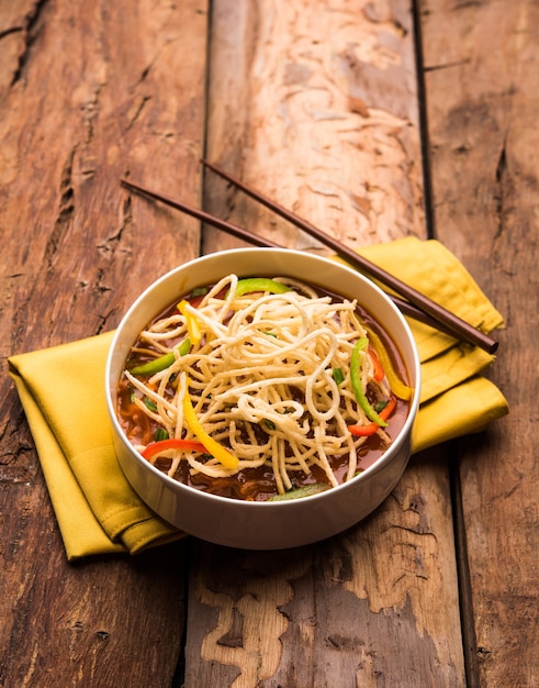 American chop suey or chopsuey is a popular indochinese food. served in a bowl with chop sticks. selective focus