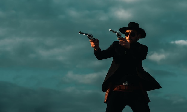 American cowboy shooting handsome brutal western guy sheriff with wild west guns vintage pistol revo