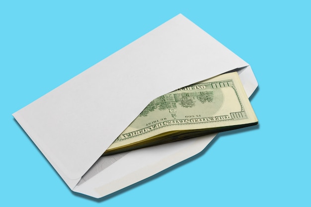 Photo american dollars in open white postal envelope on blue