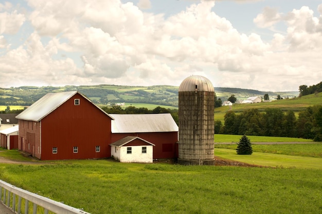 American Farm bright red barn on green field