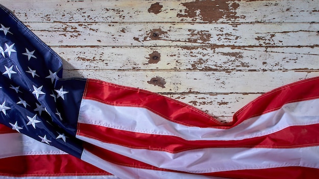 American Flag for America's 4th of July Celebration over a white wooden rustic background to mark America's Independence Day Image shot from the top view