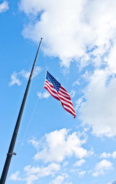 American flag on a blue sky during a windy day