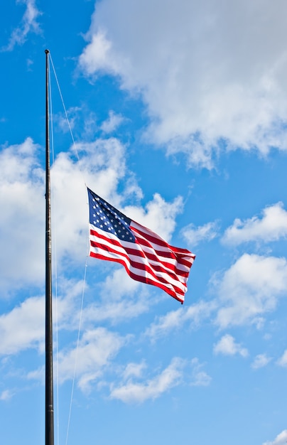 American flag on a blue sky during a windy day