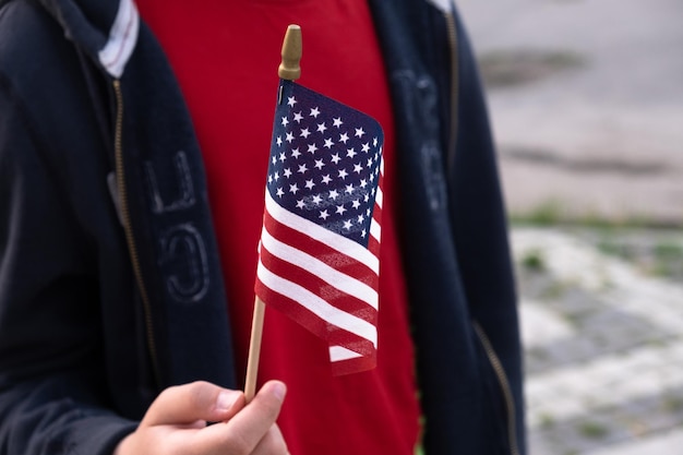 American flag in boy's hand outdoors 4th july USA independence day concept