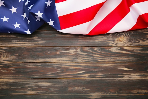 American flag on brown wooden background with copy space