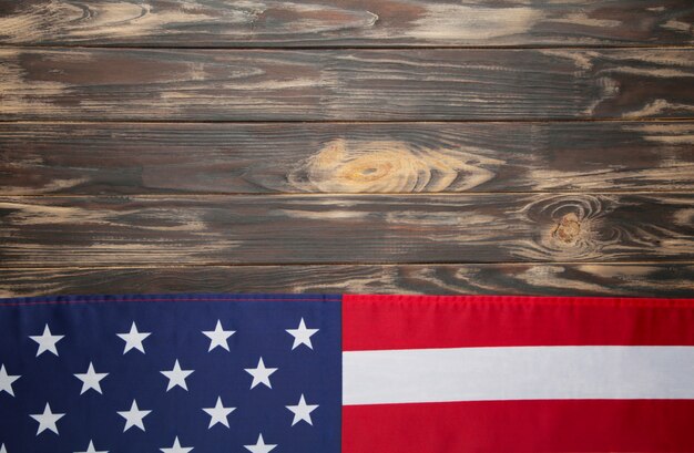American flag on brown wooden background with copy space