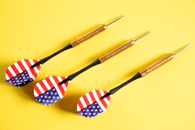 American flag darts on yellow surface