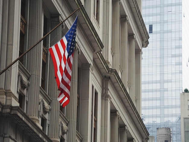 Photo american flag hanging on building in city