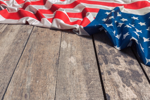 An American Flag Lying on an aged, weathered rustic wooden 