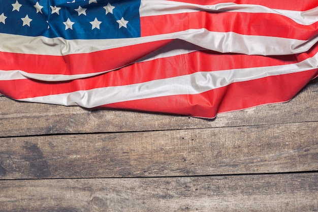 An American Flag Lying on an aged, weathered rustic wooden 