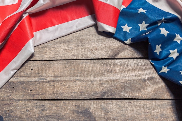 An American Flag Lying on an aged, weathered rustic wooden 