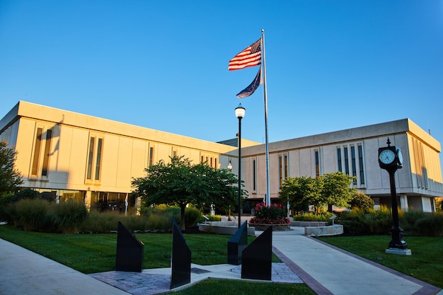 American Flag and Modern Courthouse at Sunrise with Garden