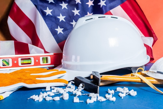 American flag and tools near the helmet labor day concept still life