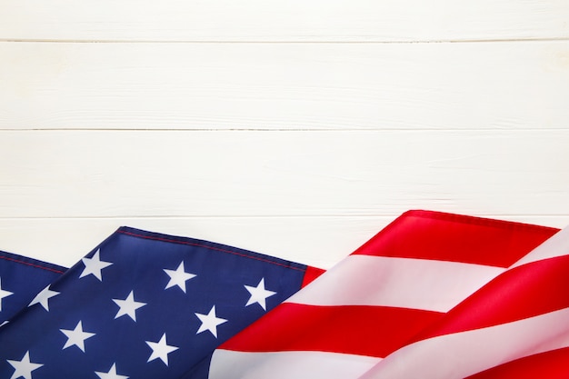 American flag on white wooden background with copy space