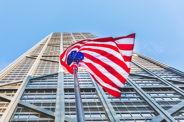 American flag with modern skyscraper 