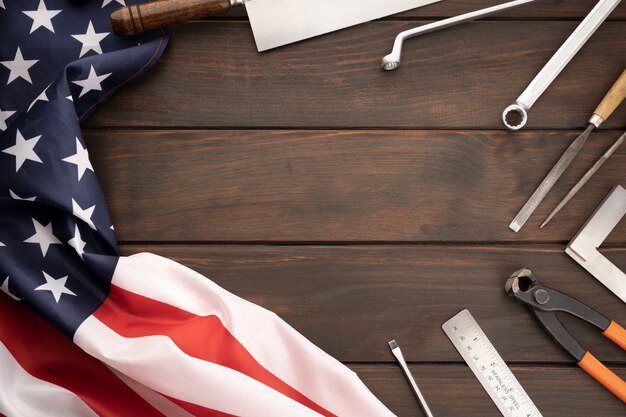 american flag and work tools on tabletop with copy space labor day concept background