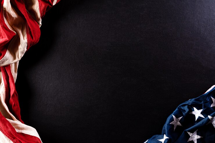 American flags  against a black  wall.