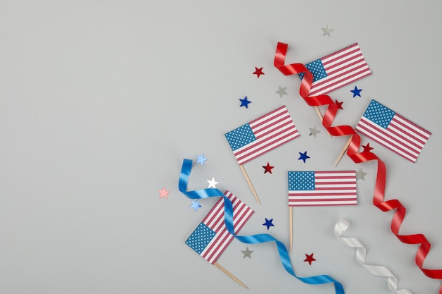 American flags, curly ribbons and stars on gray surface