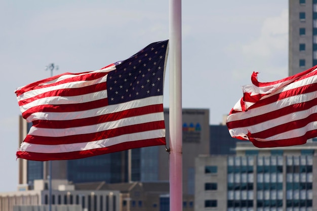 American flags waving on poles in city