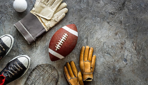 american footbal ball american football gloves and american football outfit gray background