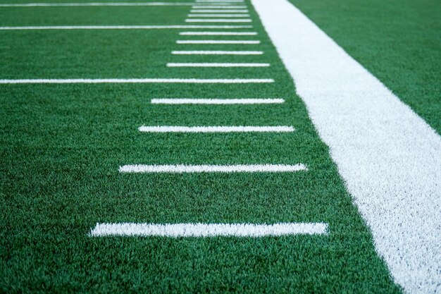 American football background with ball in stadium