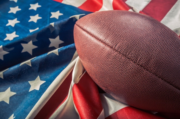 Photo american football ball on american flag