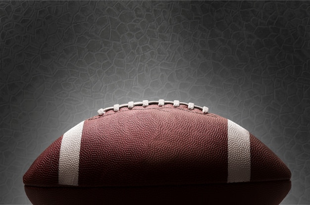 American football ball on background