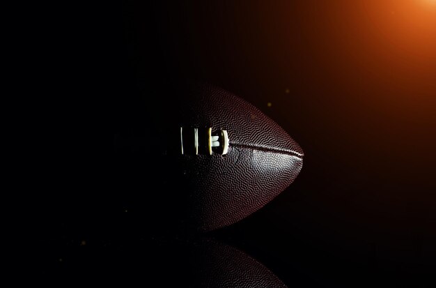 American football ball isolated on black background