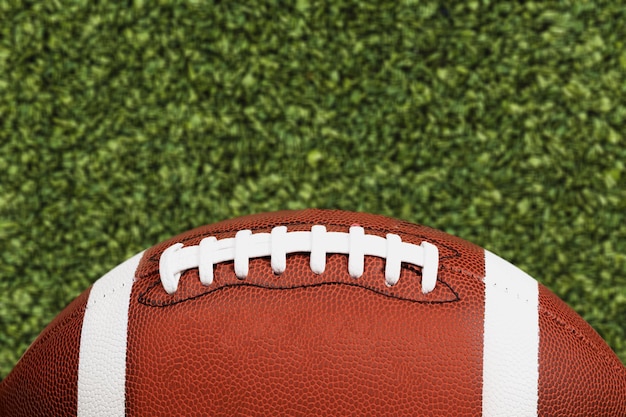 American football ball on stadium field background