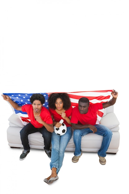 American football fans in red on the sofa