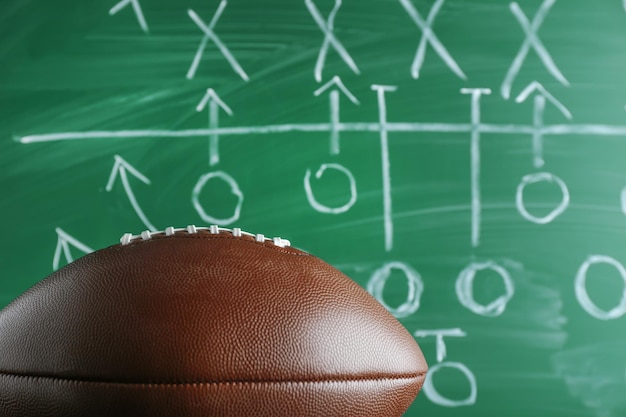 Photo american football game strategy written with chalk on blackboard