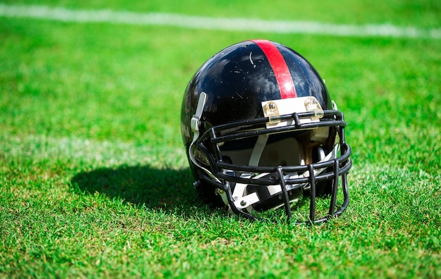 American football helmet on green grass