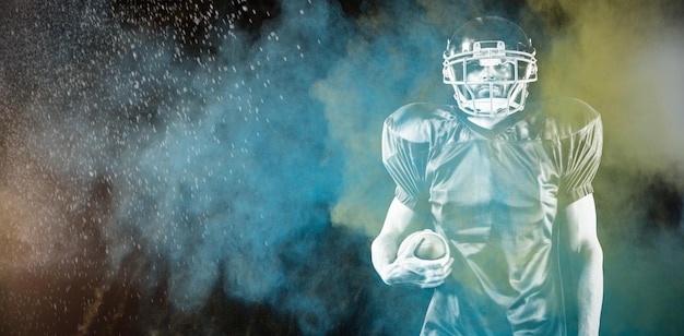 American Football Player against splashing of color powder