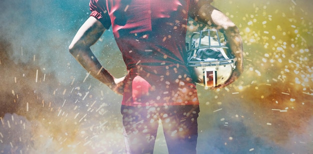 Photo american football player against splashing of powder