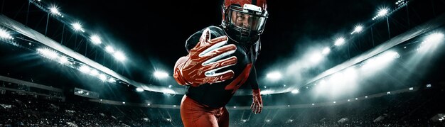 Photo american football player athlete sportsman in red helmet on stadium background sport and motivation