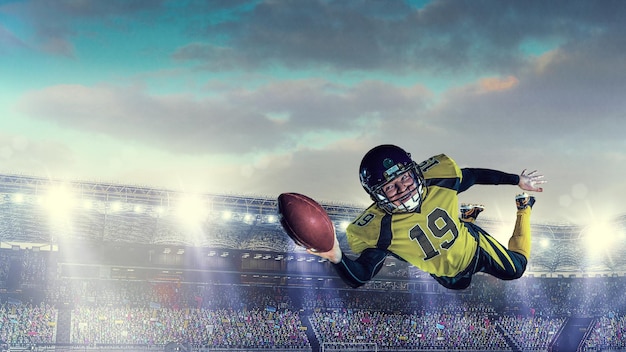american football player on the field during game in action. mixed media