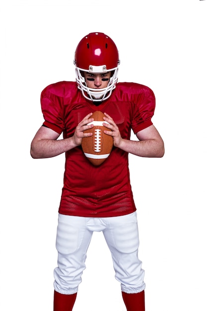 American football player holding a ball