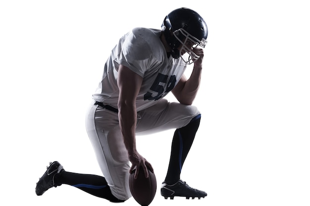 American football player holding ball