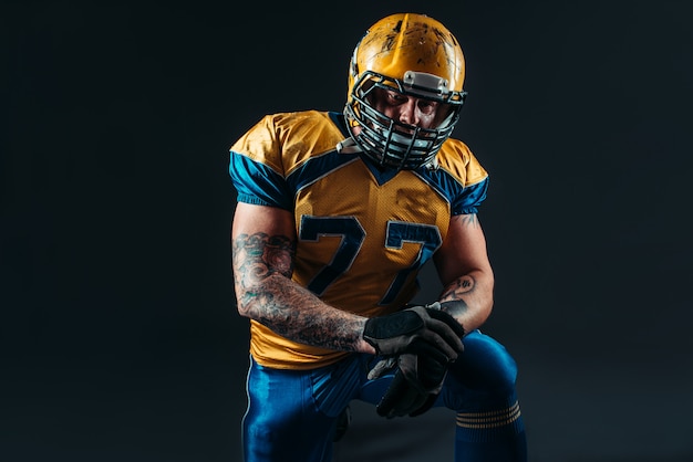 American football player holds ball in hands