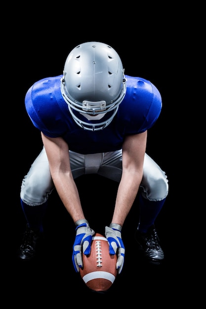 American football player placing ball