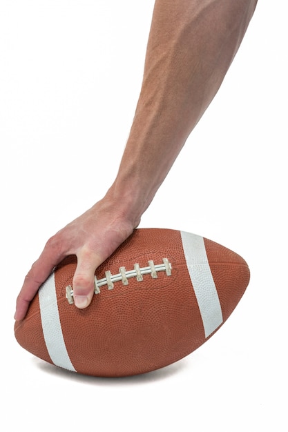 Photo american football player placing the ball