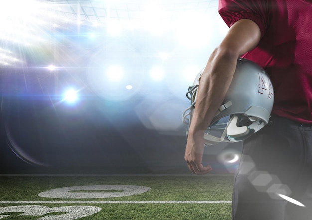 Photo american football  player standing in stadium rear view